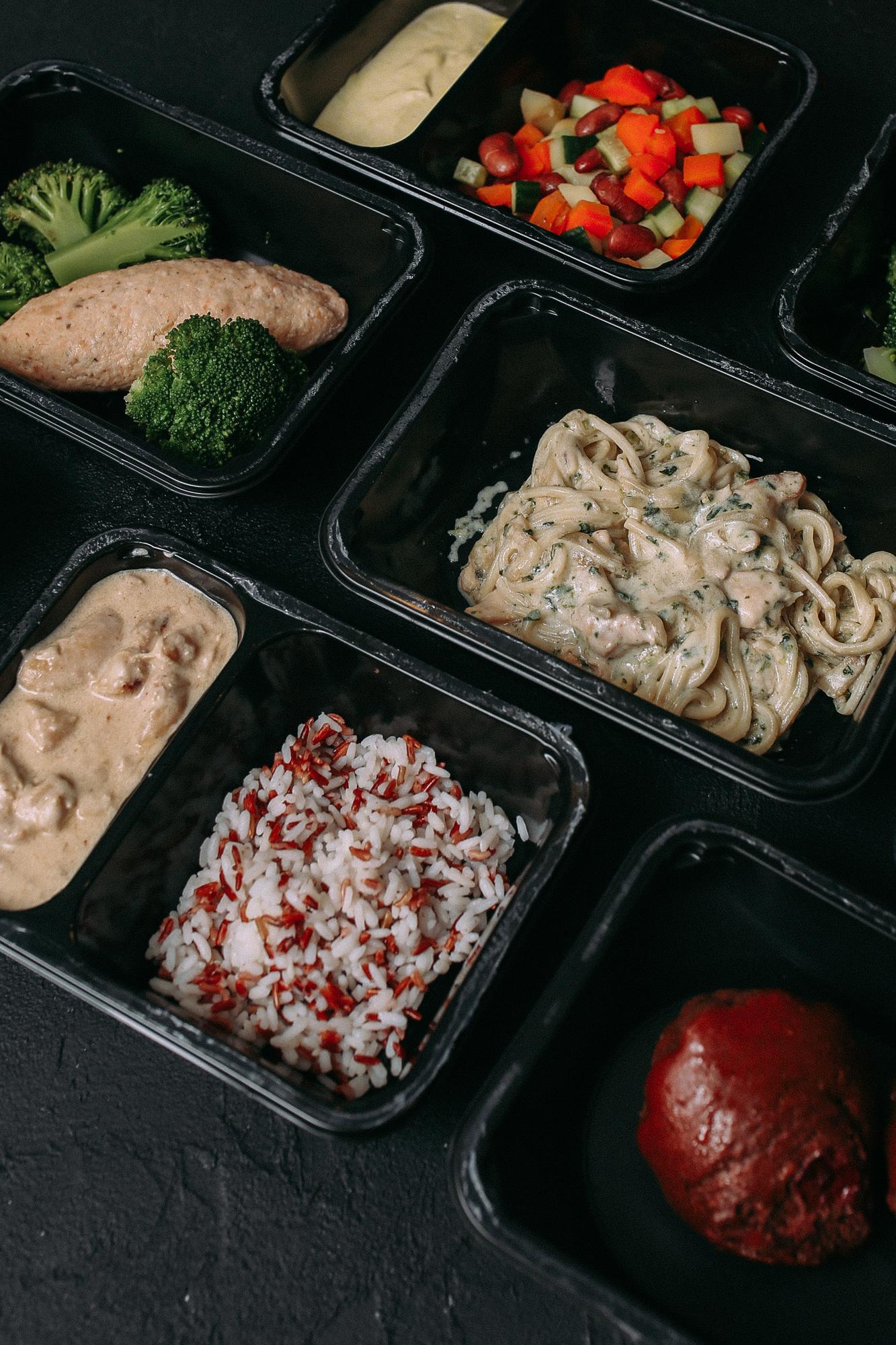 Stack of prepped meal containers ready for service