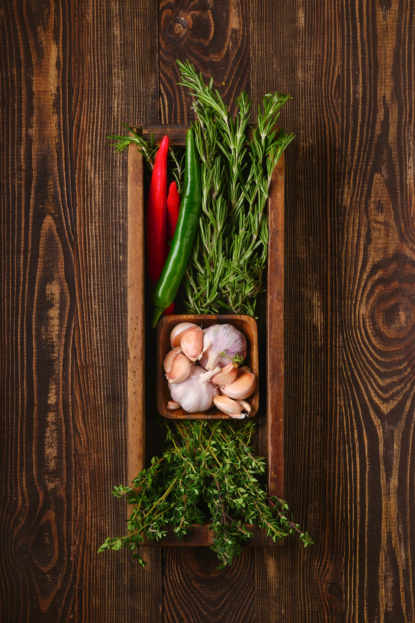 Fresh herbs and spices arranged on a board